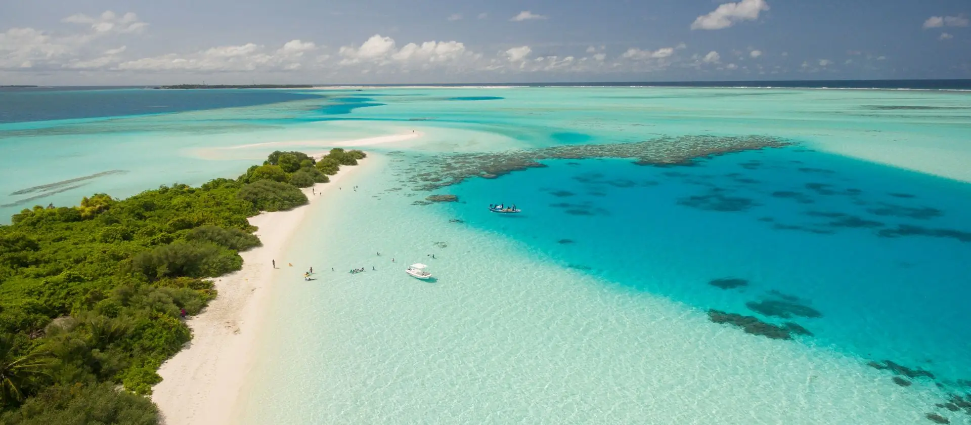 A turquoise atoll lagoon and white sand beach
